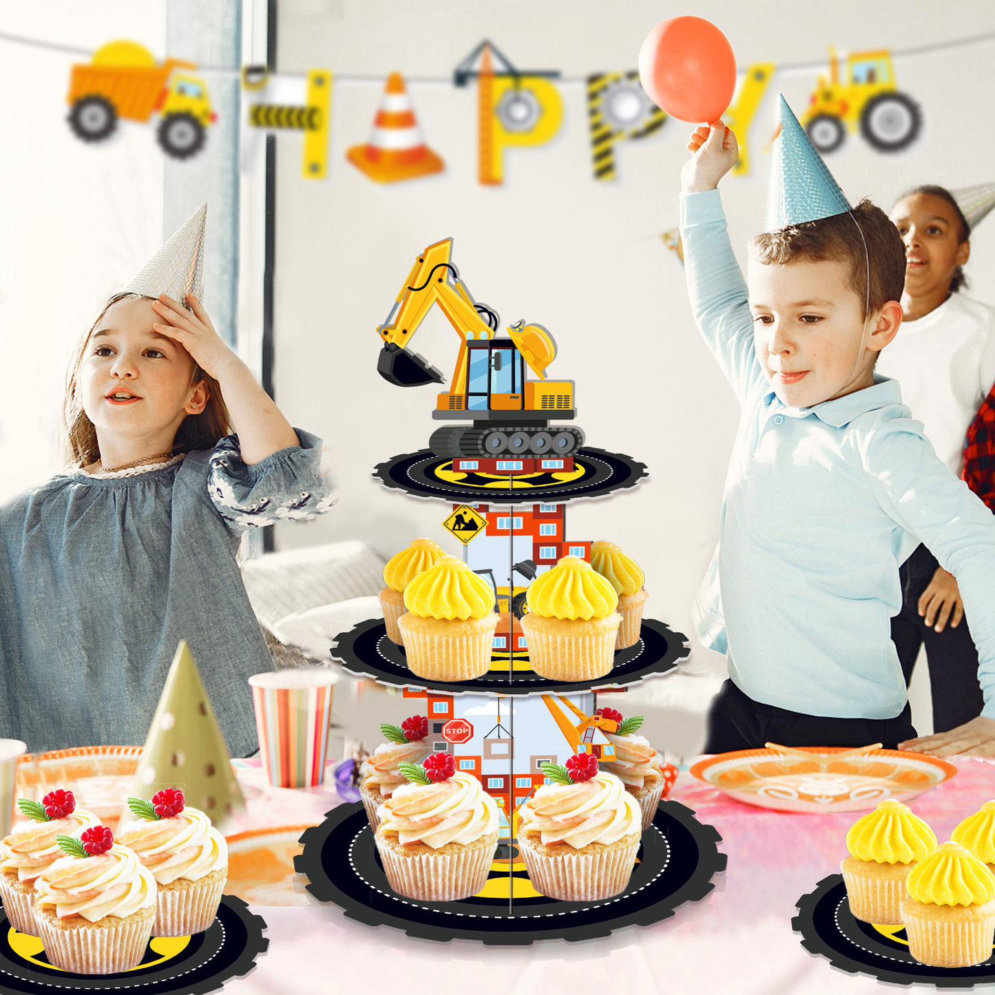 Children at a construction-themed birthday party with cupcakes and a cake stand.
