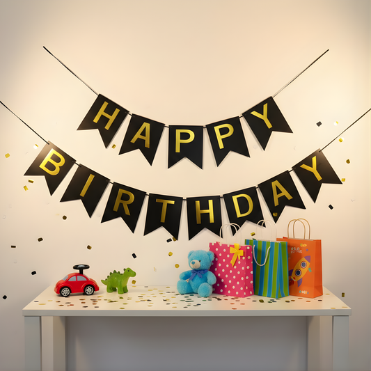 Happy Birthday banner with toys and gift bags on a table against a plain wall.