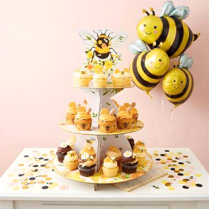 3-tier cardboard cupcake stand with bumble bee theme, decorated with yellow flowers and bees, displayed with cupcakes and matching bee balloons.