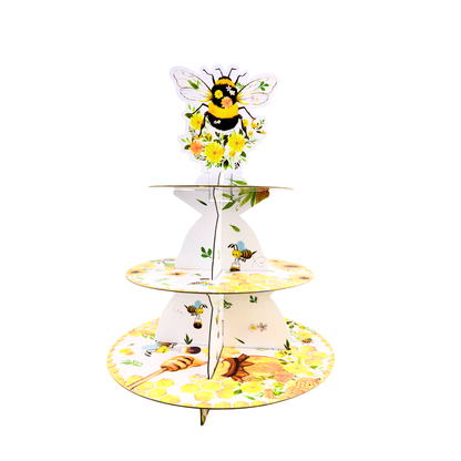 Front view of a 3-tier cardboard cupcake stand featuring a queen bee top topper and floral, honeycomb, and bee graphics.